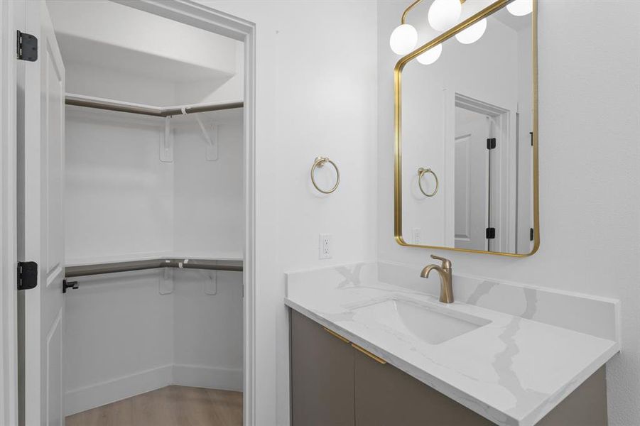 The bathroom is complete with quartz countertops, and a walk-in closet.