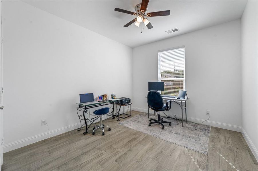 Office space featuring light wood-type flooring and a ceiling fan