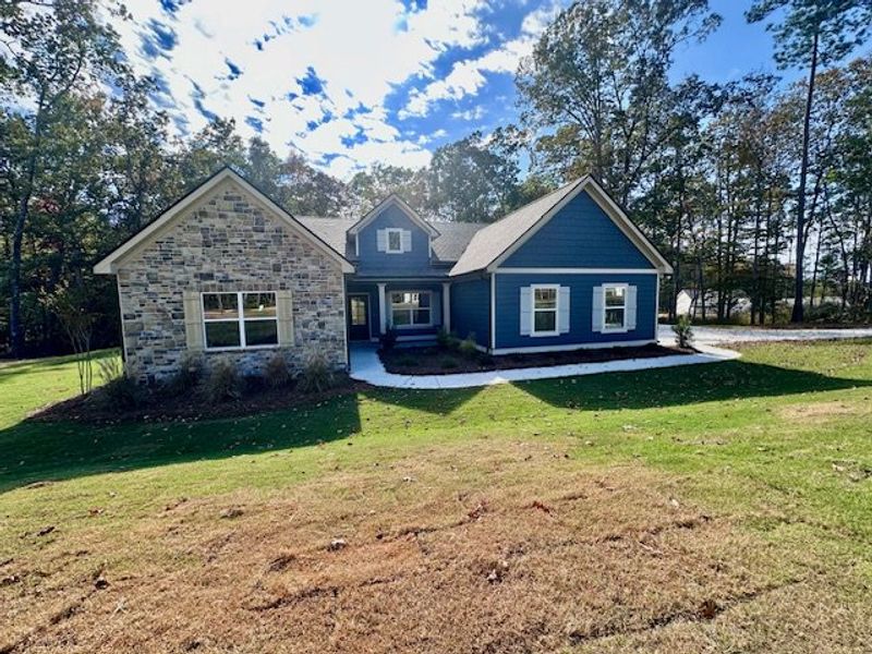Front exterior of a new home in Deer Creek, Moreland, GA, highlighting curb appeal (Image 1).