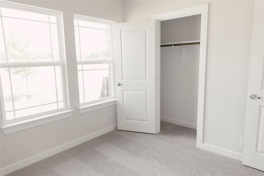 Unfurnished bedroom featuring carpet and a closet