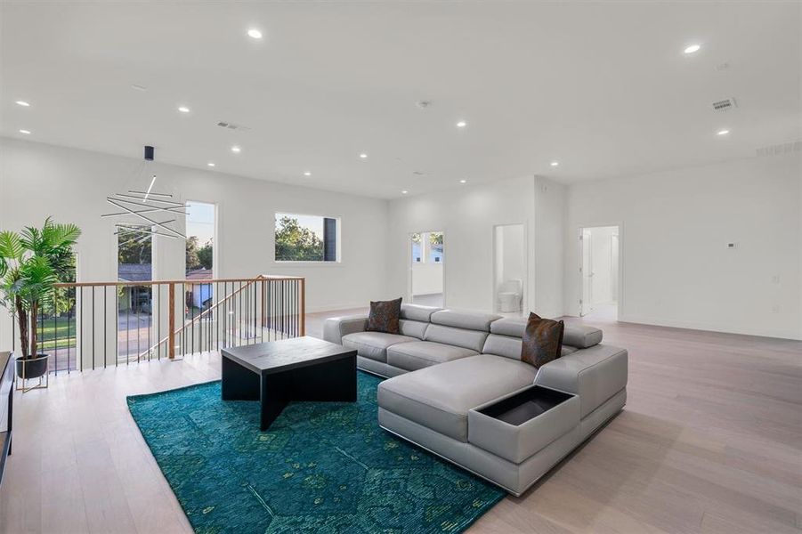 Living area with visible vents, light wood-type flooring, and recessed lighting