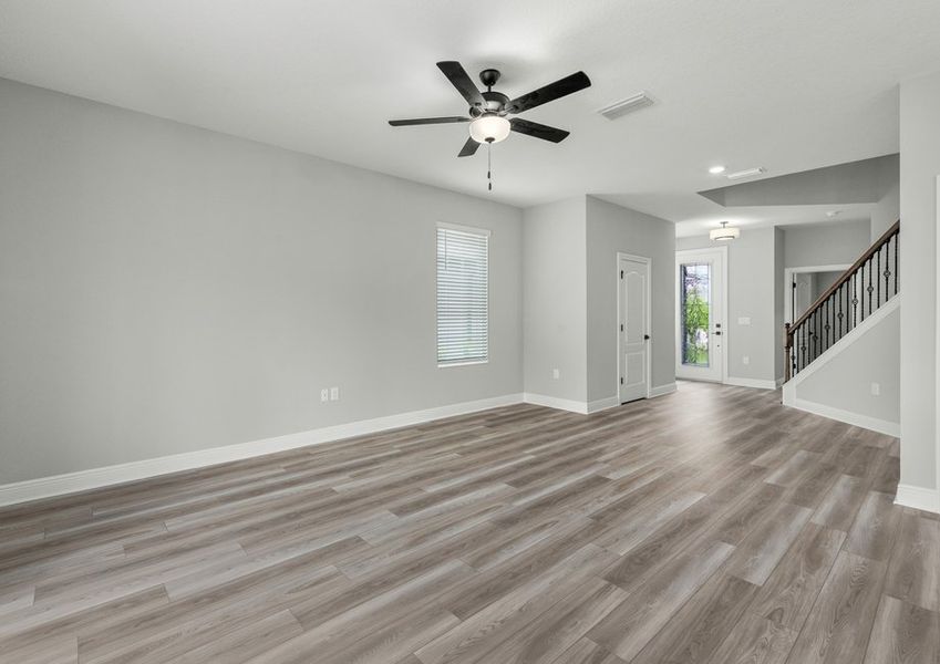 Spacious family room with a ceiling fan