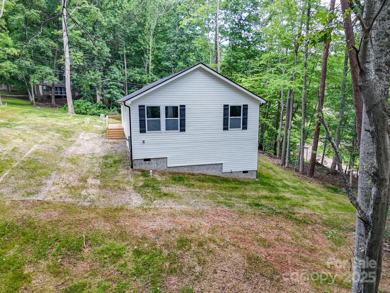 Front exterior of a new home in , Candler, NC, highlighting curb appeal (Image 24).