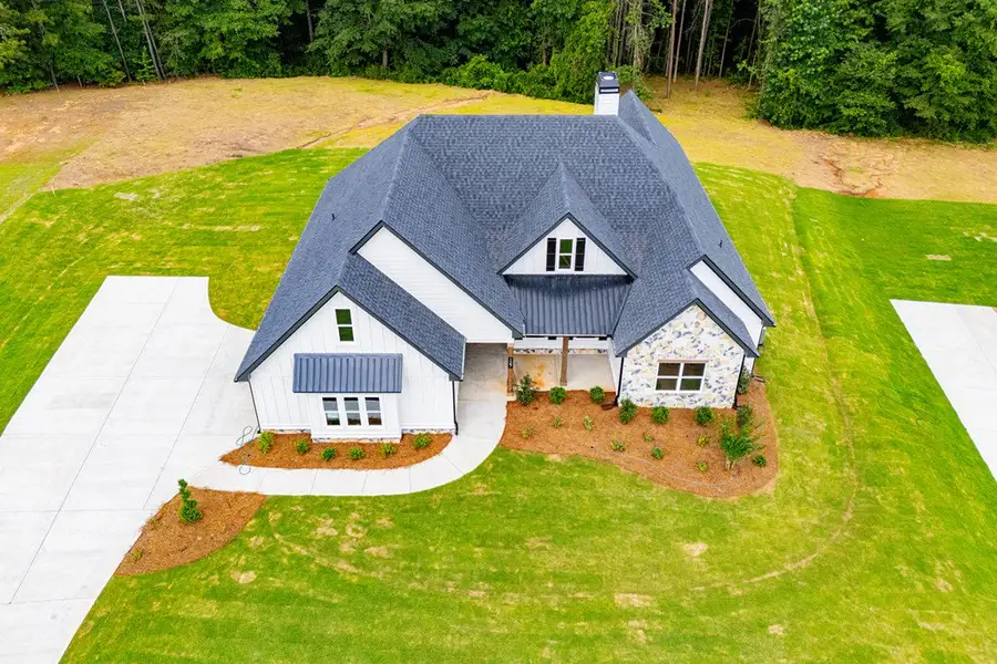 Front exterior of a new home in WOODMONT RESERVE, Roopville, GA, highlighting curb appeal (Image 45).