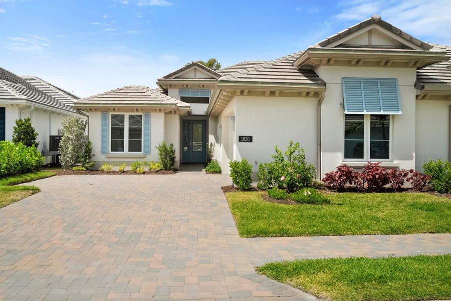 Front exterior of a new home in Lucaya Pointe, Vero Beach, FL, highlighting curb appeal (Image 1). Front exterior of a new home in Lucaya Pointe, Vero Beach, FL, highlighting curb appeal (Image 1).