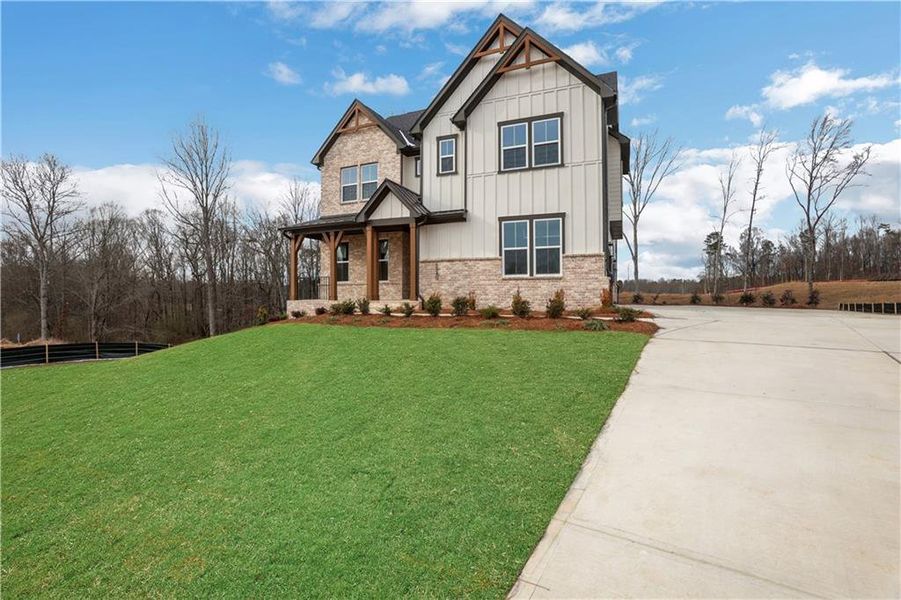 Front exterior of a new home in Acacia, Cumming, GA, highlighting curb appeal (Image 24). Front exterior of a new home in Acacia, Cumming, GA, highlighting curb appeal (Image 24).