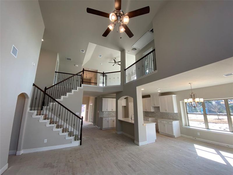 WOW! This is an amazing great room with iron spindles open to below!