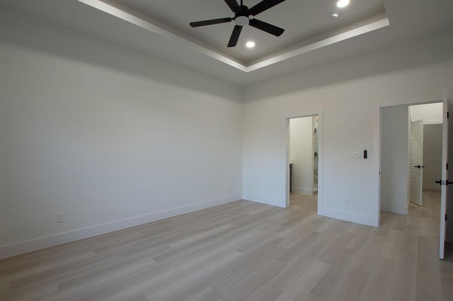 Carpeted spare room with ceiling fan