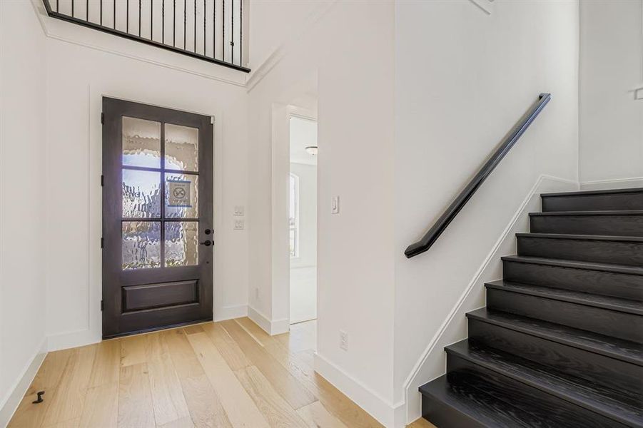 Foyer entrance with light wood-type flooring and stairs Foyer entrance with light wood-type flooring and stairs