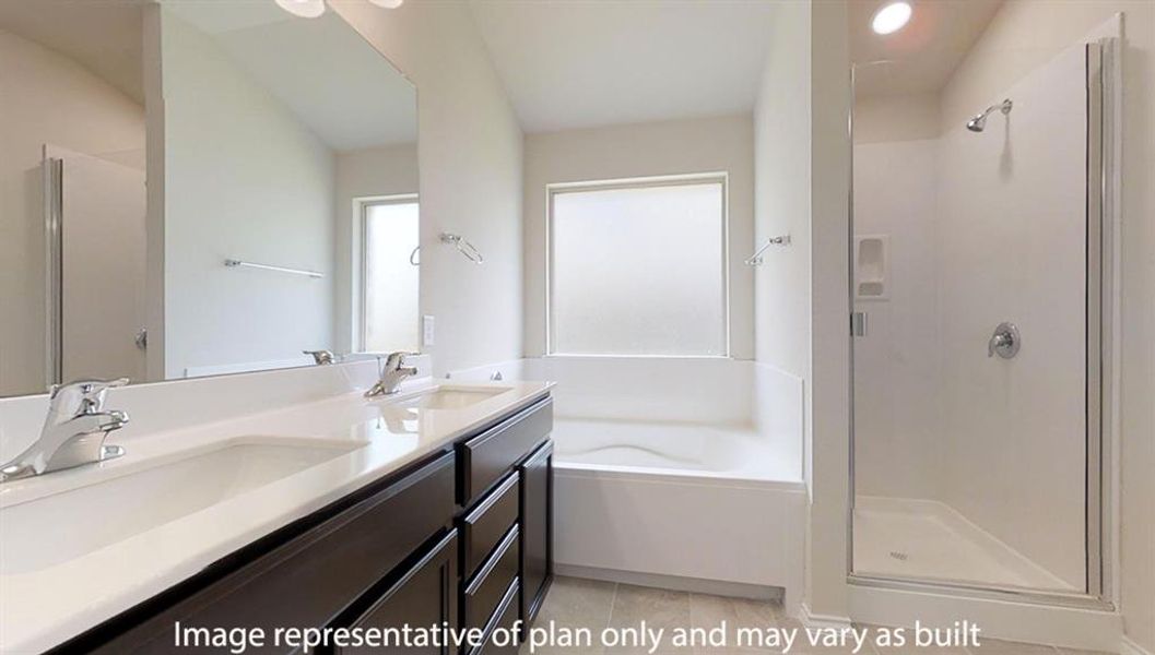 Bathroom featuring a stall shower, a garden tub, and double vanity Bathroom featuring a stall shower, a garden tub, and double vanity