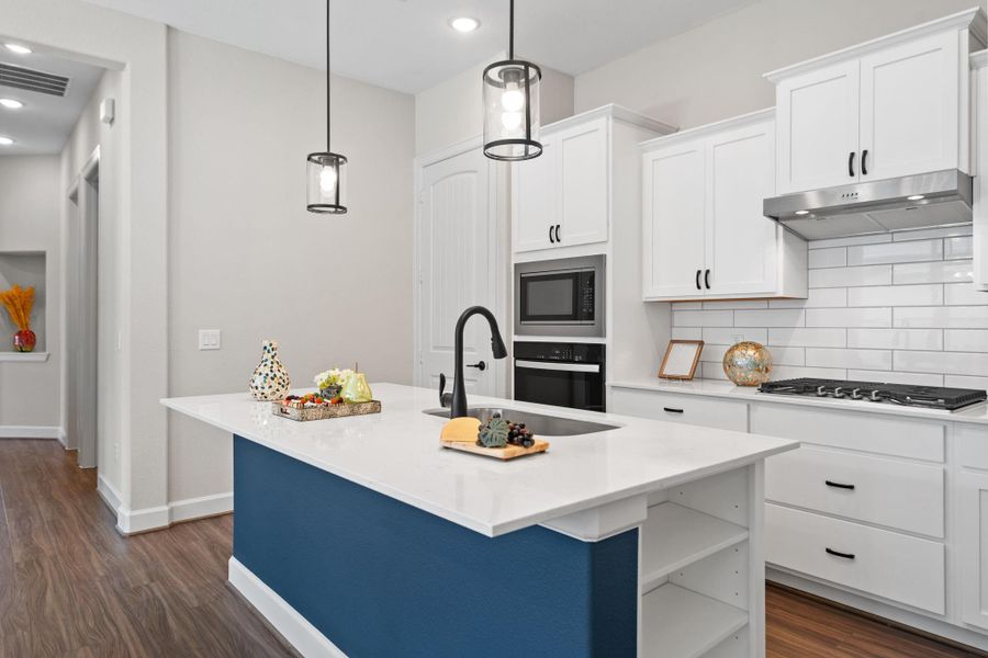 Designed for both beauty and function, the Palazzo kitchen offers easy access, ample prep space, and an inviting island perfect for casual mornings or hosting friends in Winfrey Estates. Image depicts home as-is.