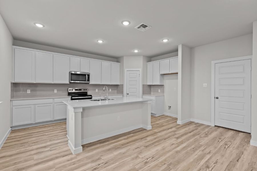 A kitchen with white cabinets. A kitchen with white cabinets.