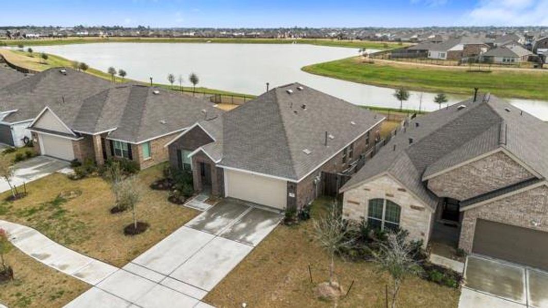 Front exterior of a new home in Sterling Point at Baytown Crossings: Wildflower II Collection, Baytown, TX, highlighting curb appeal (Image 2). Front exterior of a new home in Sterling Point at Baytown Crossings: Wildflower II Collection, Baytown, TX, highlighting curb appeal (Image 2).