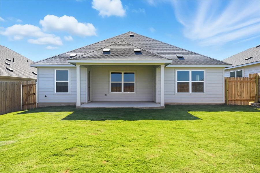 Back of property featuring roof with shingles, a patio, and a fenced backyard