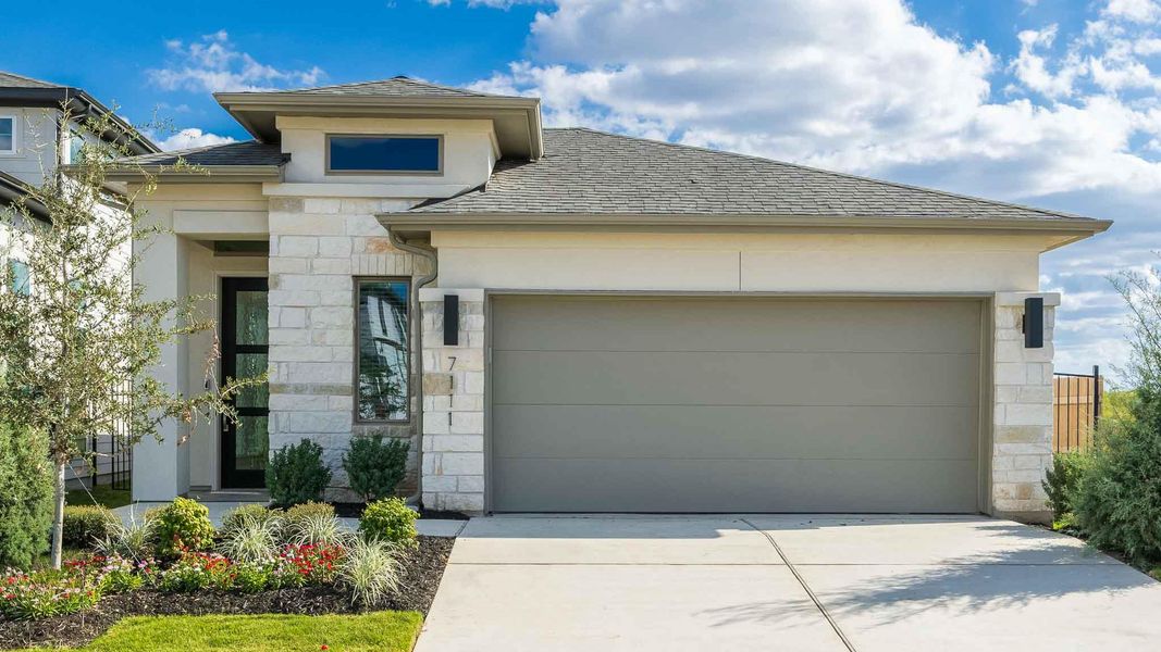 View of front of home with stone siding, a garage, driveway, roof with shingles, and stucco siding View of front of home with stone siding, a garage, driveway, roof with shingles, and stucco siding