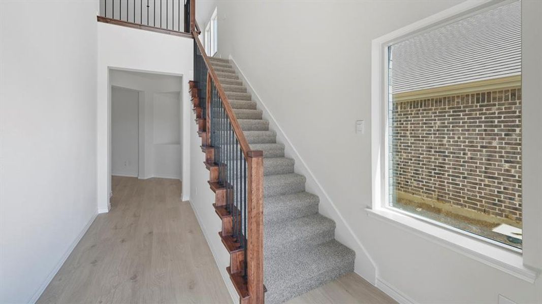 Stairway featuring wood finished floors and baseboards Stairway featuring wood finished floors and baseboards