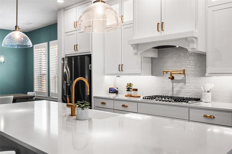 Beautifully appointed kitchen with ceiling-height cabinetry, refined gold hardware, and a timeless, elevated design.