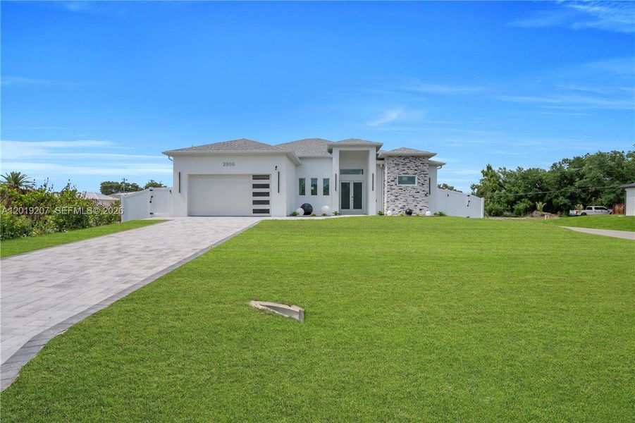 Front exterior of a new home in , Lehigh Acres, FL, highlighting curb appeal (Image 26). Front exterior of a new home in , Lehigh Acres, FL, highlighting curb appeal (Image 26).
