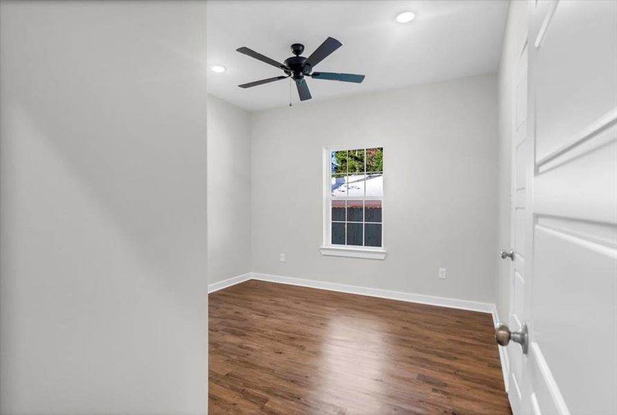 Unfurnished room with baseboards, wood finished floors, recessed lighting, and a ceiling fan