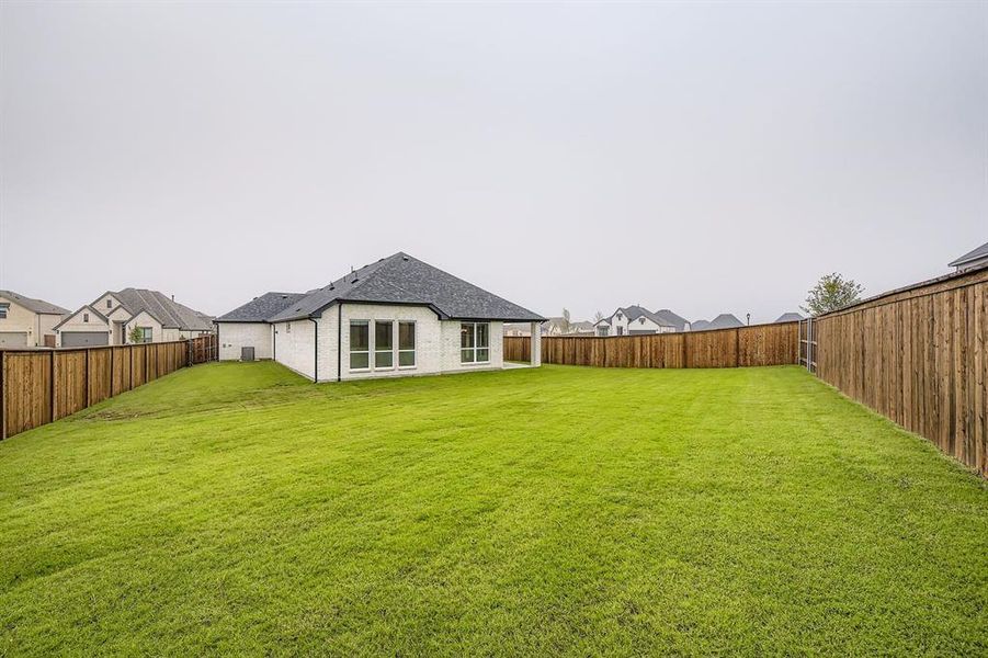 Fenced backyard with a patio area