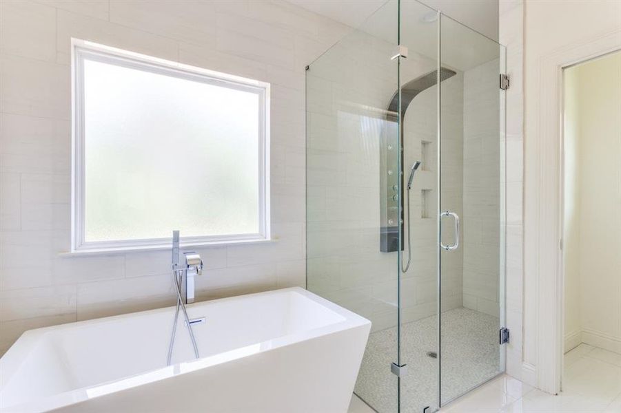 Full bathroom with a stall shower and a soaking tub