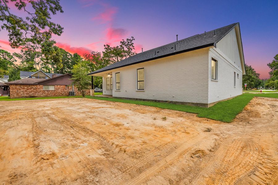 Backyard surrounded by mature trees, providing privacy, shade, and a serene, natural setting for relaxation and outdoor enjoyment.