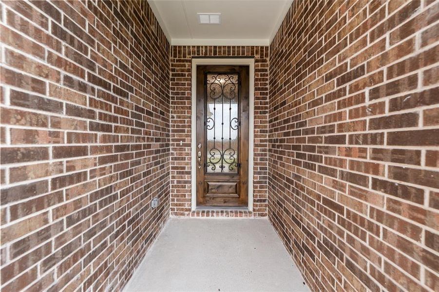 Doorway to property with brick siding Doorway to property with brick siding