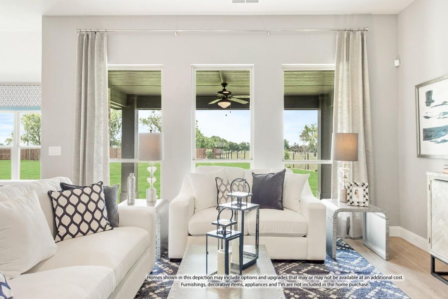 Living room with white sofas, large windows, gray curtains, and a blue patterned area rug Living room with white sofas, large windows, gray curtains, and a blue patterned area rug