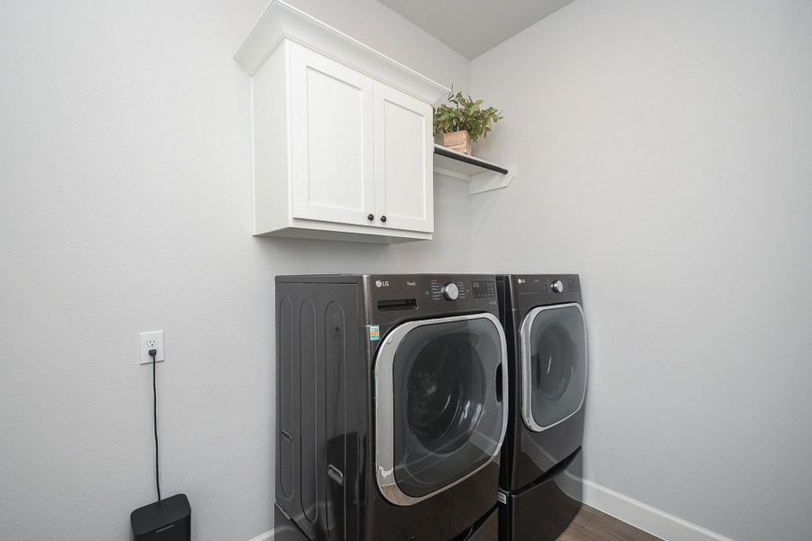 Laundry room with storage and refrigerator space