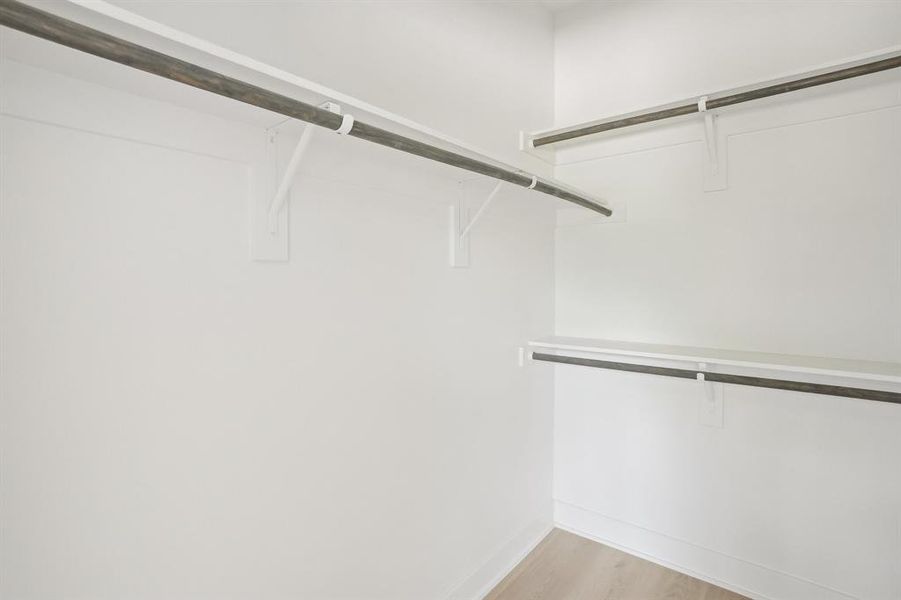 Spacious closet featuring light wood-type flooring