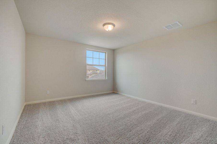 Guest bedroom in the Pearl floorplan at a Meritage Homes community.