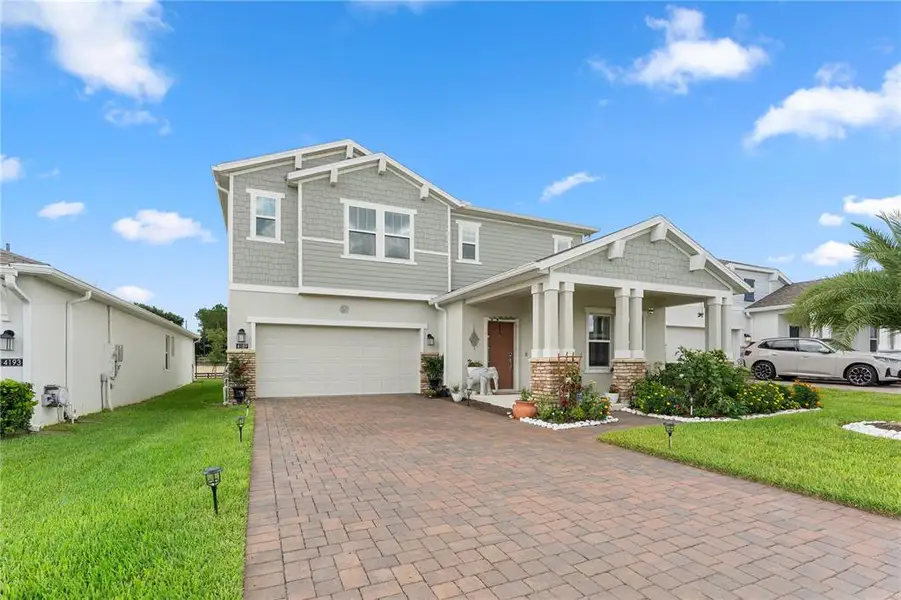 Front exterior of a new home in Golden Orchard, Apopka, FL, highlighting curb appeal (Image 2). Front exterior of a new home in Golden Orchard, Apopka, FL, highlighting curb appeal (Image 2).