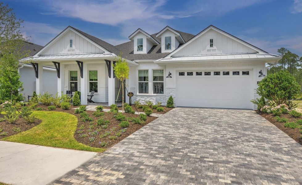 Front exterior of a new home in Plantation Bay, Ormond Beach, FL, highlighting curb appeal (Image 21).