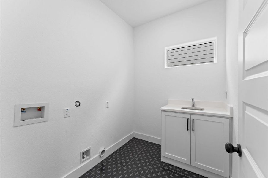 This indoor utility room, located upstairs by the bedrooms, is ready to hold a full-sized washer and dryer.