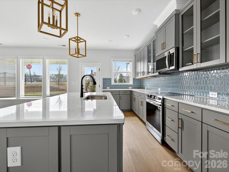 42" cabinets with soft close doors and drawers, quartz countertops, tile backsplash. Frigidaire gallery appliances. Microwave is exhaust vented to the outside. Large pantry with solid shelving