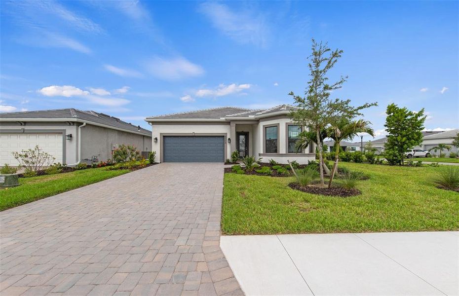 Front exterior of a new home in Del Webb Catalina, Lakewood Ranch, FL, highlighting curb appeal (Image 2). Front exterior of a new home in Del Webb Catalina, Lakewood Ranch, FL, highlighting curb appeal (Image 2).