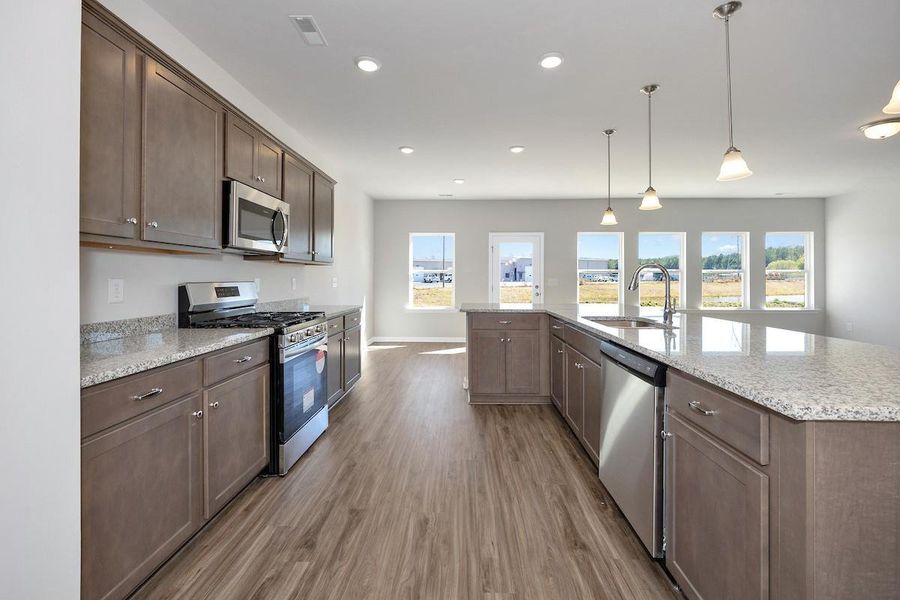 The Avery- Kitchen. Home under construction. Sample floor plan photo used for illustrative purposes only. Upgrades, selections options, and colors will vary.