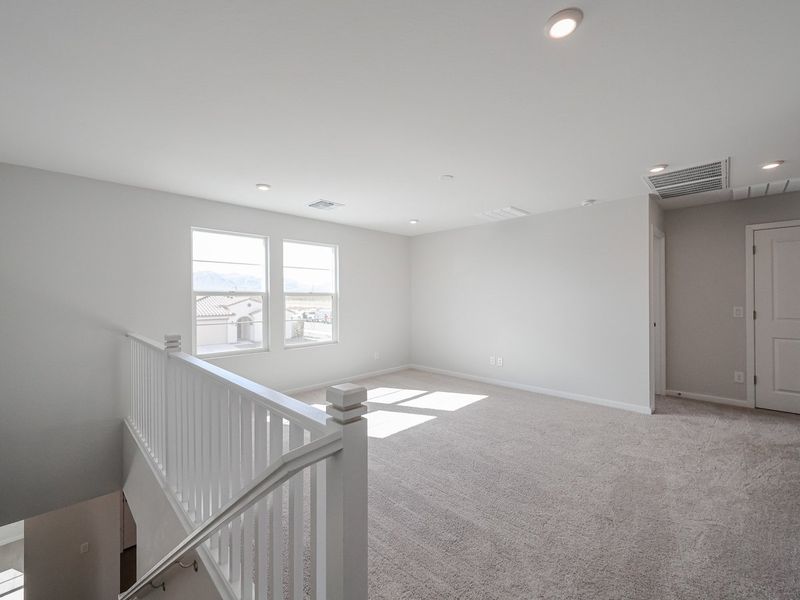 A room with a staircase and windows.