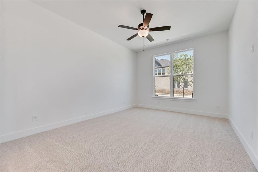 Unfurnished room with light carpet and ceiling fan Unfurnished room with light carpet and ceiling fan
