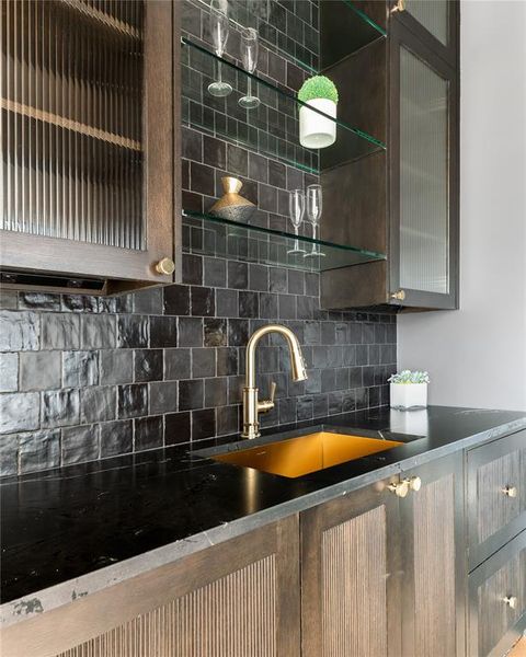 Kitchen featuring tasteful backsplash and sink