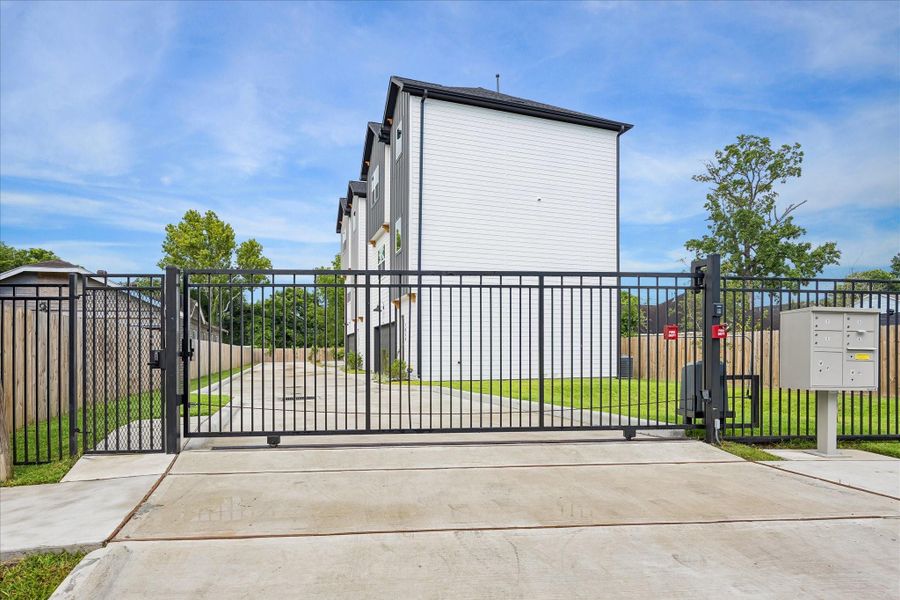 The private driveway is secured by a motorized entry gate, with a separate pedestrian gate providing convenient access for guests. The private driveway is secured by a motorized entry gate, with a separate pedestrian gate providing convenient access for guests.