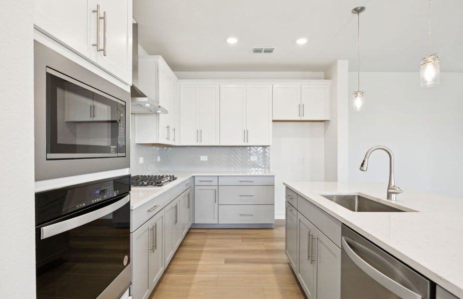 High-end gourmet kitchen with premium finishes and upgraded appliances *Real home pictured High-end gourmet kitchen with premium finishes and upgraded appliances *Real home pictured