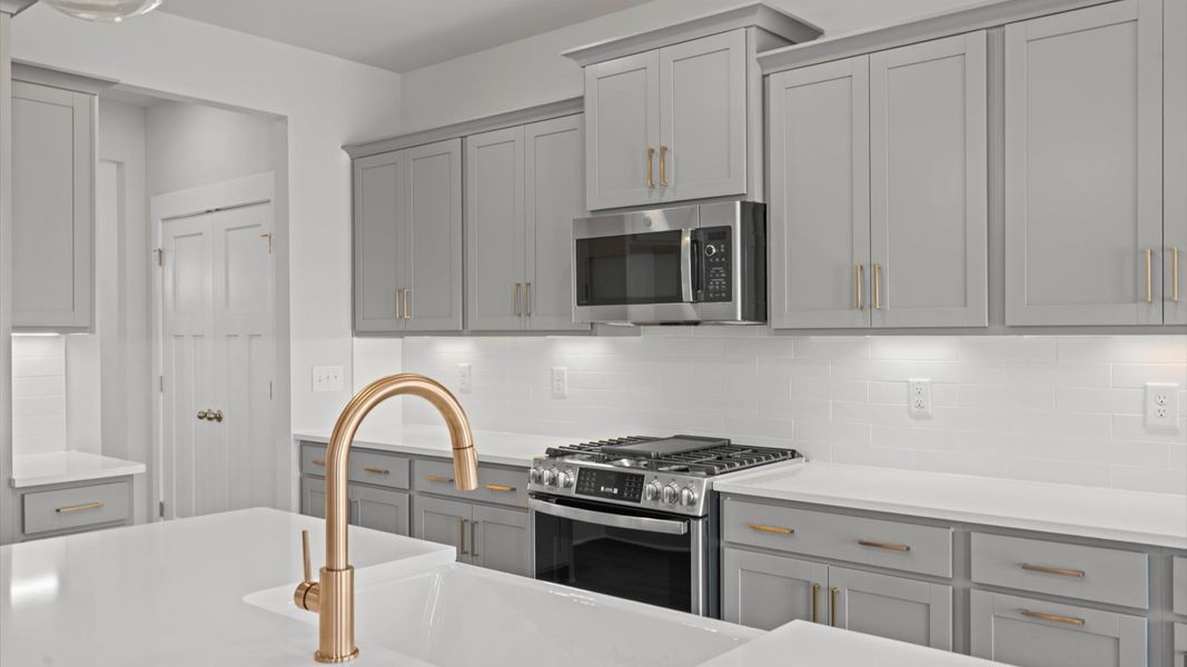 First-class kitchen with a spacious 7-foot island perfect for entertaining beneath designer pendant lighting