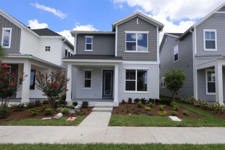 Front exterior of a new home in Laureate Park at Lake Nona - Garden Series, Orlando, FL, highlighting curb appeal (Image 21).