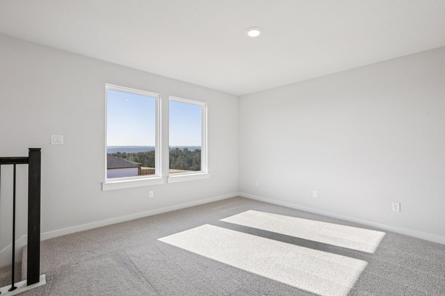 A room with a rug and a window.