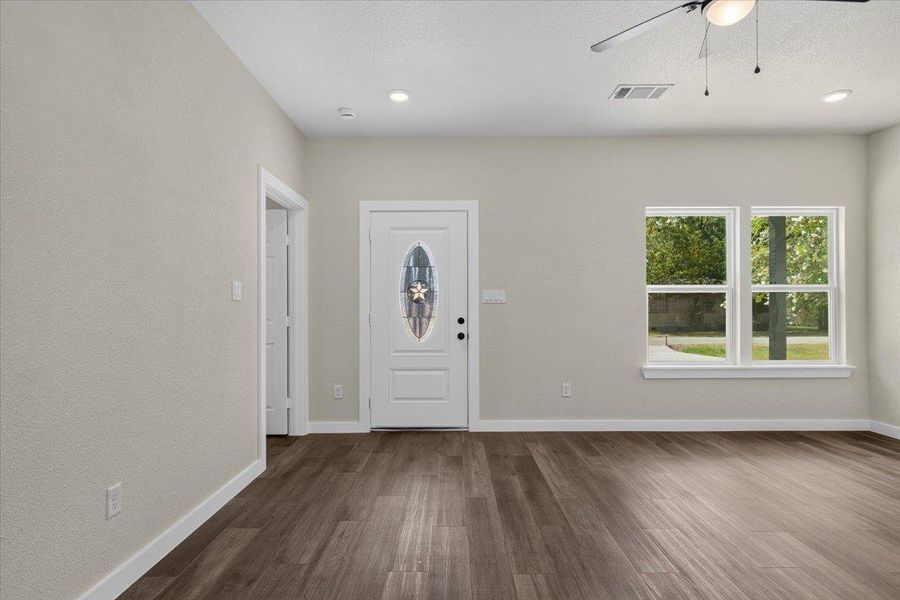 Rich wood-look flooring and a glass-inset entry door ground this welcoming reception area. Rich wood-look flooring and a glass-inset entry door ground this welcoming reception area.