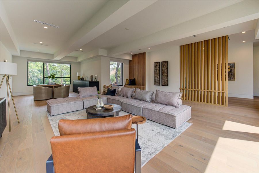 Game room with flexible lounge, wet bar, and media space.