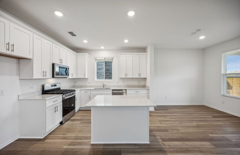 Airy kitchen with oversized island *real home pictured