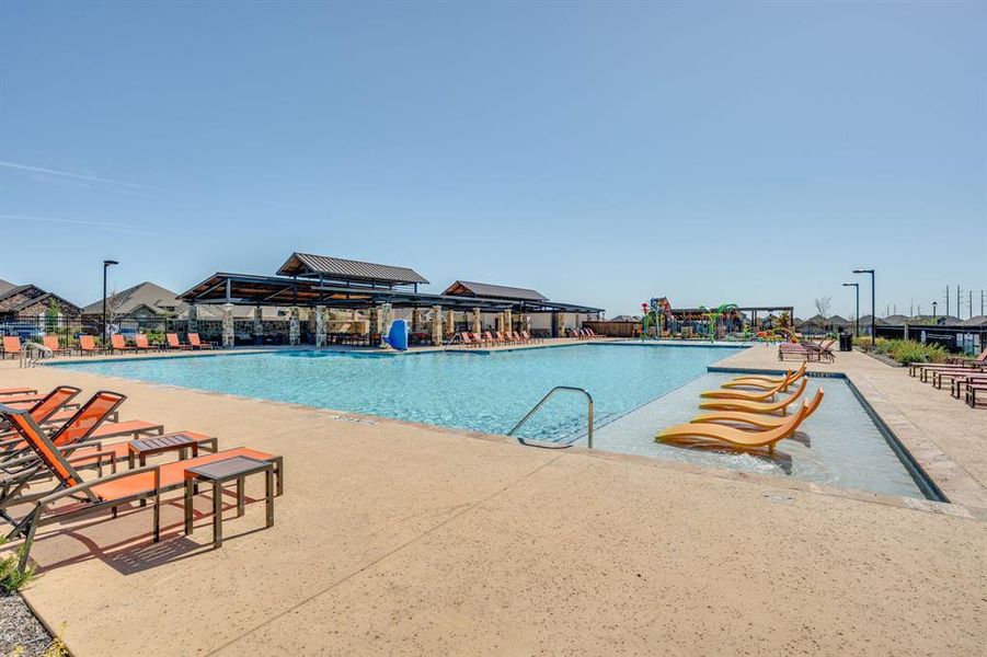 Community pool with a patio area Community pool with a patio area