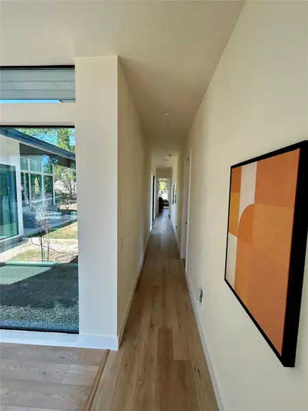 Hall with light wood finished floors and baseboards Hall with light wood finished floors and baseboards